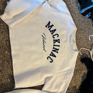 This is a white and blue cropped hoodie from Mackinaw Island.